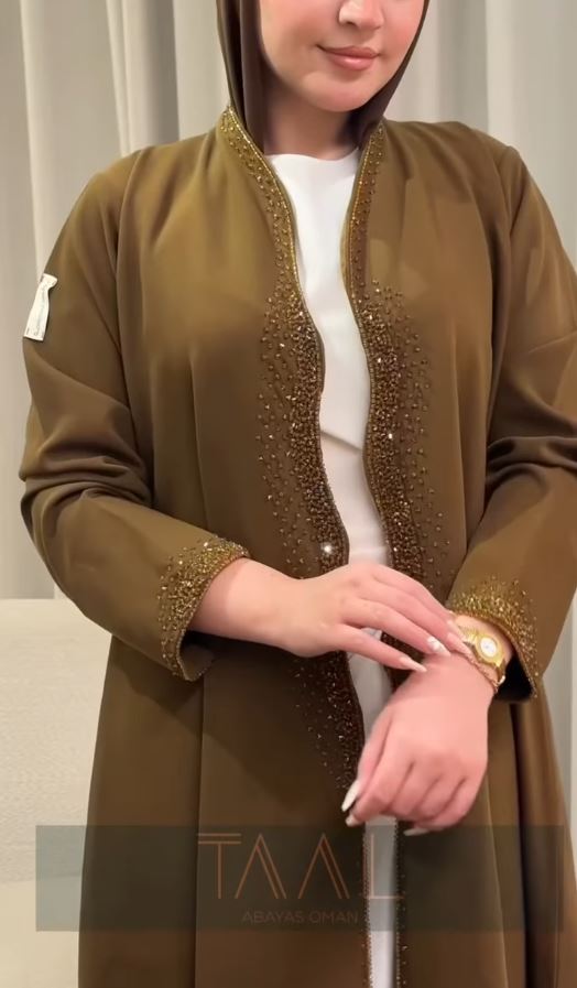 Close-up of olive beaded abaya cuff detail