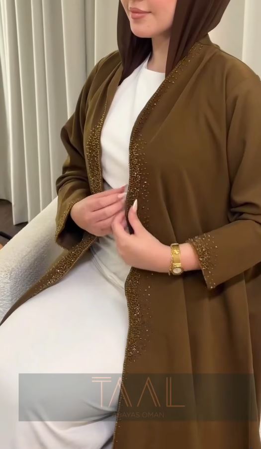 Olive and khaki abaya with beaded detailing, close-up